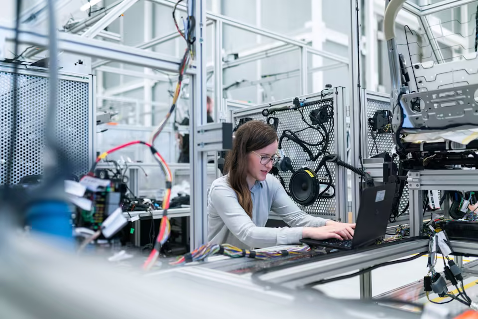 Technician at work in an industrial or manufacturing environment.